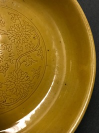 A Chinese monochrome yellow dish with incised lotus design, Kangxi mark, 20th C.
